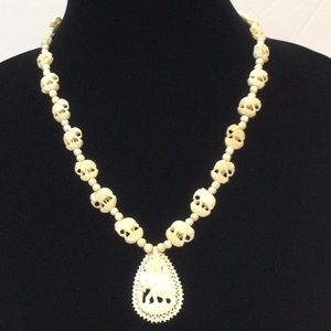 Elephant necklace carved from camel or ox bone